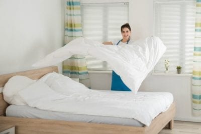 Airbnb Host Pockets the Cleaning Fee, Woman Changing Bed Linens