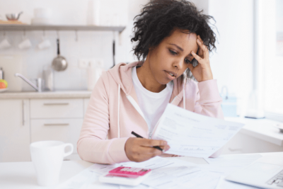 Can't Afford Insurance, Woman Looking at Bills